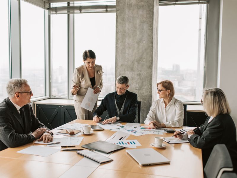 Real estate professionals discussing a home value calculator report